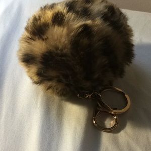 Faux fur cheetah print bag accessory with a clip